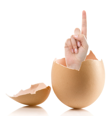 Hand with broken egg isolated on white backround. Woman index finger isolated on white backgroundの写真素材