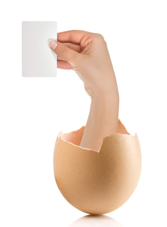 Hand with broken egg isolated on white backroundの写真素材