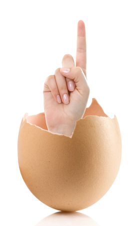 Hand with broken egg isolated on white backround. Woman index finger isolated on white backgroundの写真素材