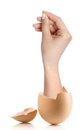 Hand with broken egg isolated on white backroundの写真素材