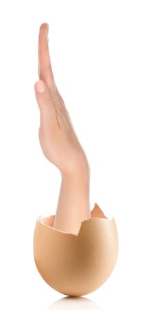 Hand with broken egg isolated on white backroundの写真素材