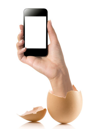 Hand with broken egg isolated on white backround. Hand of young man holding smart phone white screen isolated on white background with clipping pathの写真素材