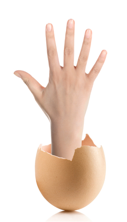 Hand with broken egg isolated on white backroundの写真素材