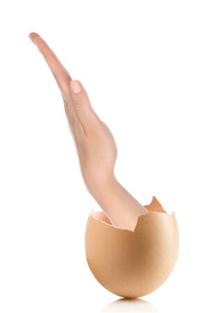 Hand with broken egg isolated on white backroundの写真素材