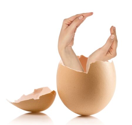 Hand with broken egg isolated on white backroundの写真素材