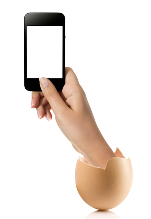 Hand with broken egg isolated on white backround. Hand of young man holding smart phone white screen isolated on white background with clipping pathの写真素材