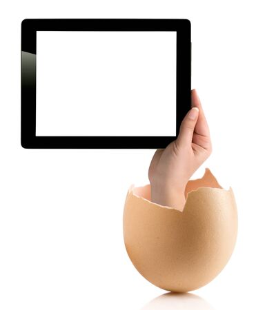 Hand holding a tablet computer with white screen. Hand with broken egg isolated on white backround. Hand holding tablet pc isolated on white background with blank screen.の写真素材