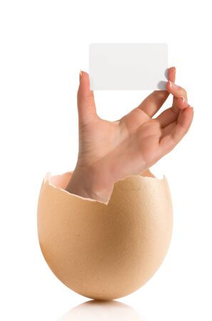 Hand with broken egg isolated on white backroundの写真素材