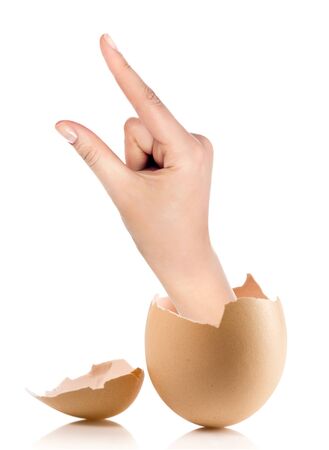 Hand with broken egg isolated on white backroundの写真素材