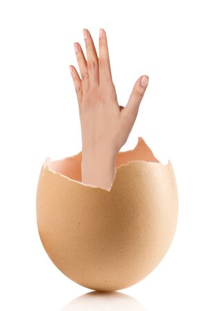 Hand with broken egg isolated on white backroundの写真素材