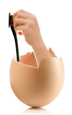 Hand with broken egg isolated on white backroundの写真素材