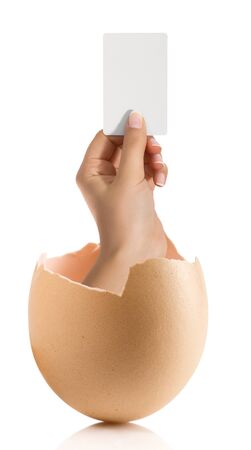 Hand with broken egg isolated on white backroundの写真素材