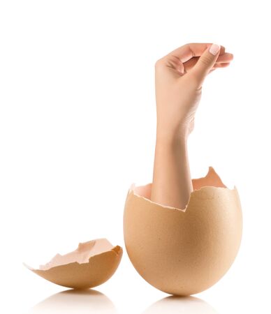 Hand with broken egg isolated on white backroundの写真素材