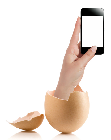Hand with broken egg isolated on white backround. Hand of young man holding smart phone white screen isolated on white background with clipping pathの写真素材
