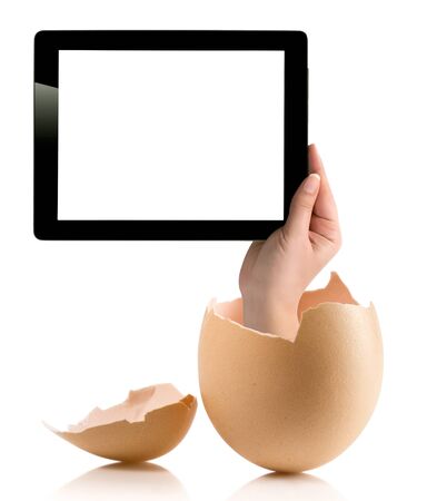 Hand holding a tablet computer with white screen. Hand with broken egg isolated on white backround. Hand holding tablet pc isolated on white background with blank screen.の写真素材