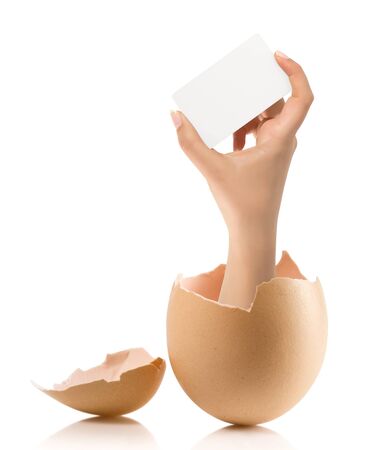 Hand with broken egg isolated on white backroundの写真素材