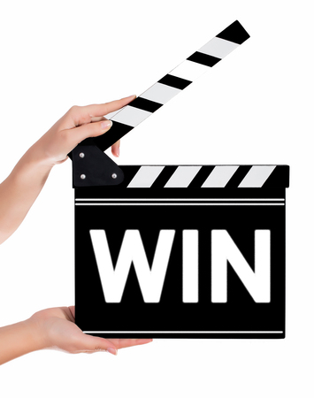 Hands holding a clapper board.Isolated on white backroundの写真素材