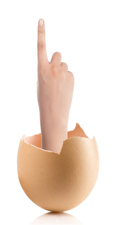 Hand with broken egg isolated on white backroundの写真素材