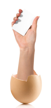 Hand with broken egg isolated on white backroundの写真素材