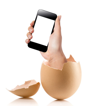 Hand with broken egg isolated on white backround. Hand of young man holding smart phone white screen isolated on white background with clipping pathの写真素材
