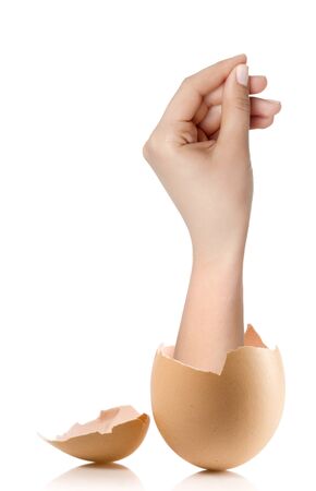 Hand with broken egg isolated on white backroundの写真素材