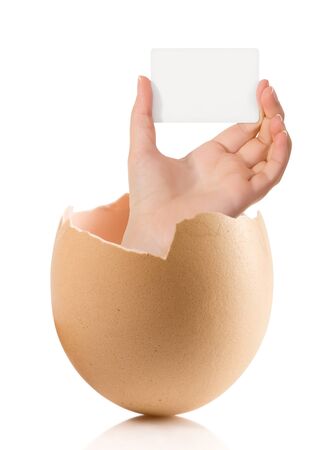 Hand with broken egg isolated on white backroundの写真素材