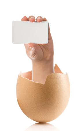 Hand with broken egg isolated on white backroundの写真素材