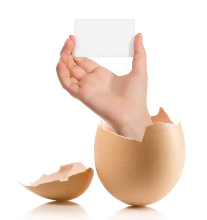 Hand with broken egg isolated on white backroundの写真素材
