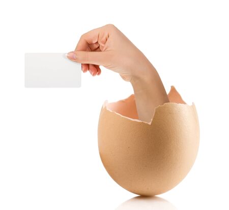 Hand with broken egg isolated on white backroundの写真素材