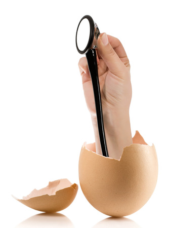 Hand with broken egg isolated on white backroundの写真素材