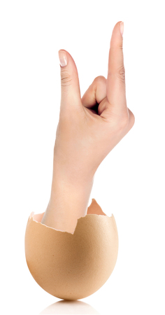 Hand with broken egg isolated on white backroundの写真素材