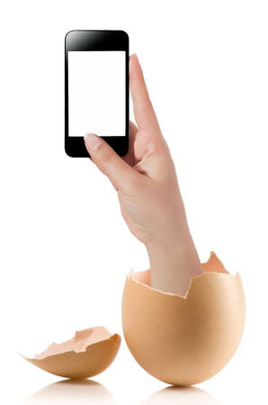 Hand with broken egg isolated on white backround. Hand of young man holding smart phone white screen isolated on white background with clipping pathの写真素材