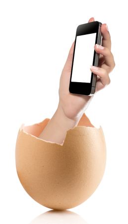 Hand with broken egg isolated on white backround. Hand of young man holding smart phone white screen isolated on white background with clipping pathの写真素材