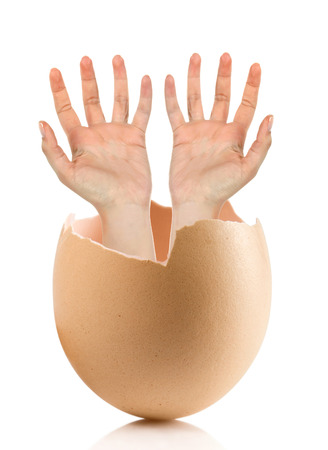 Hand with broken egg isolated on white backroundの写真素材