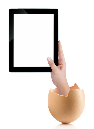 Hand holding a tablet computer with white screen. Hand with broken egg isolated on white backround. Hand holding tablet pc isolated on white background with blank screen.の写真素材