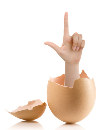 Hand with broken egg isolated on white backroundの写真素材