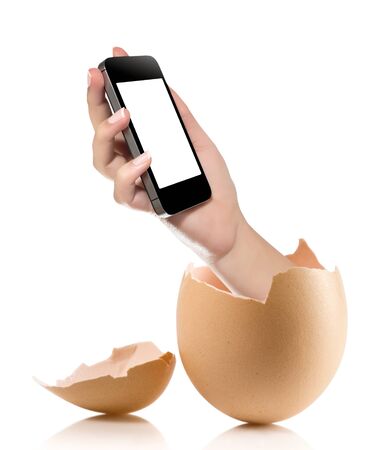 Hand with broken egg isolated on white backround. Hand of young man holding smart phone white screen isolated on white background with clipping pathの写真素材
