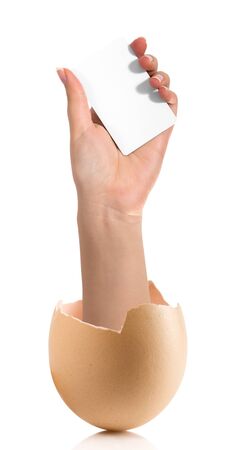 Hand with broken egg isolated on white backroundの写真素材