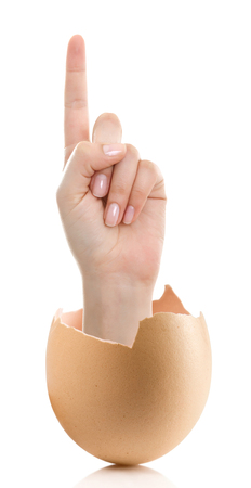 Hand with broken egg isolated on white backround. Woman index finger isolated on white backgroundの写真素材