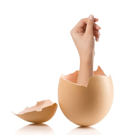 Hand with broken egg isolated on white backroundの写真素材