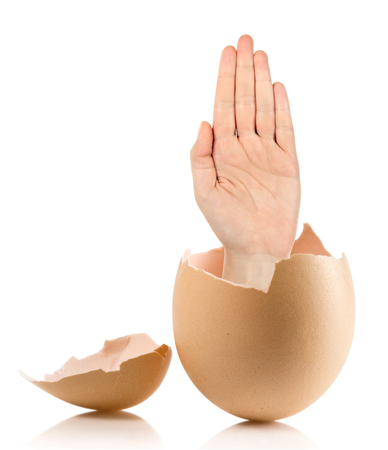 Hand with broken egg isolated on white backroundの写真素材
