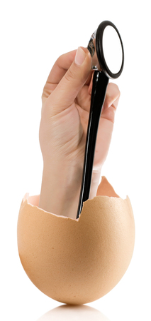 Hand with broken egg isolated on white backroundの写真素材