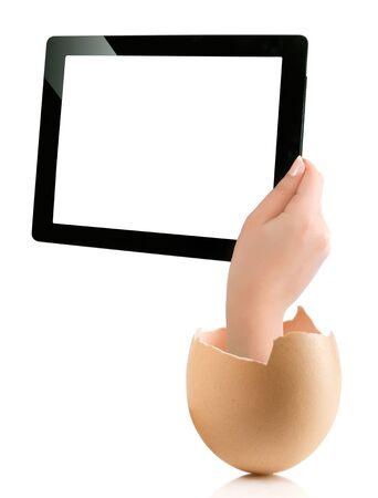 Hand holding a tablet computer with white screen. Hand with broken egg isolated on white backround. Hand holding tablet pc isolated on white background with blank screen.の写真素材