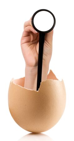 Hand with broken egg isolated on white backroundの写真素材