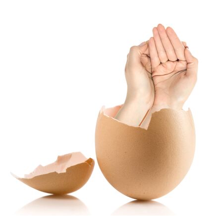 Hand with broken egg isolated on white backroundの写真素材