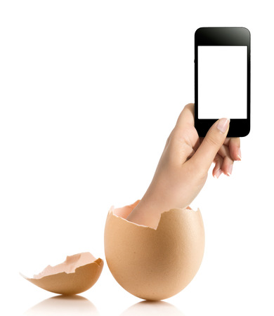 Hand with broken egg isolated on white backround. Hand of young man holding smart phone white screen isolated on white background with clipping pathの写真素材