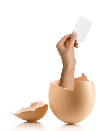 Hand with broken egg isolated on white backroundの写真素材