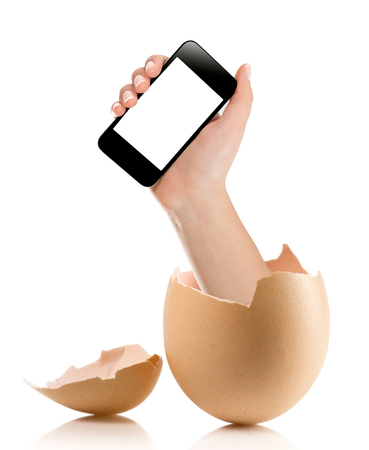 Hand with broken egg isolated on white backround. Hand of young man holding smart phone white screen isolated on white background with clipping pathの写真素材
