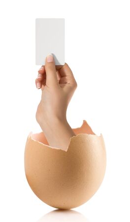 Hand with broken egg isolated on white backroundの写真素材