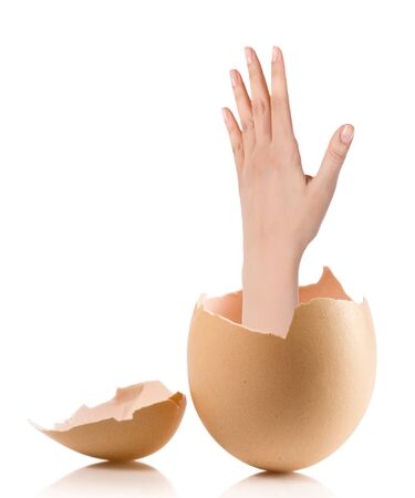 Hand with broken egg isolated on white backroundの写真素材